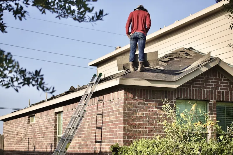 Professional roofer working on a residential roof in Industrial District